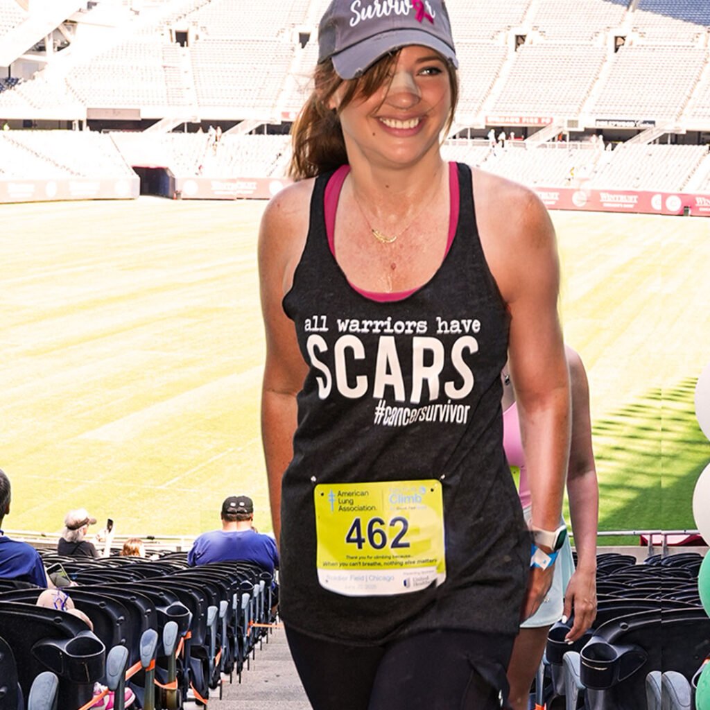 Amber Tripp Perez crossing the finish line at the Chicago Fight for Air Climb at Soldier Field